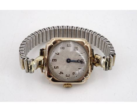 A 1920s lady's 9ct gold wristlet watch, having a rose engine turned silvered face with blued steel Breguet hands, in a cusped