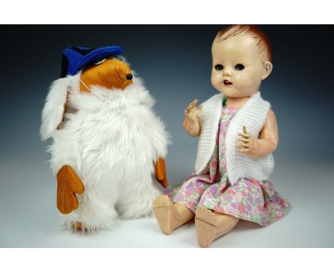 A vintage plush Womble school boy, 30 cm, together with a 1950s Pedigree "walking talking" baby doll, 50 cm