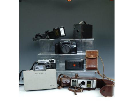 Various cameras including a Bell and Howell 624EE Autoset Cine Camera, a No.2 Kodak Brownie, an Olympus Trip 35, a vest pocke