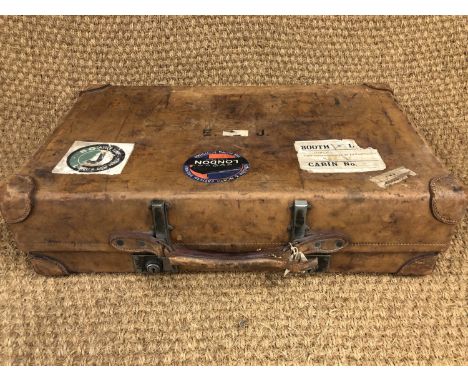 A vintage hide luggage case bearing an SS Hildebrand, Booth Line paper label, 73 cm x 44 cm x 19 cm