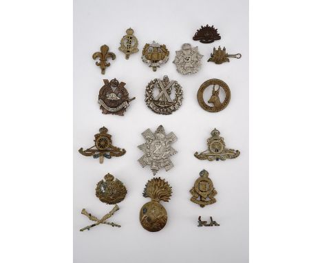 A small collection of British and Commonwealth army cap and collar badges, a shoulder title and qualification badge