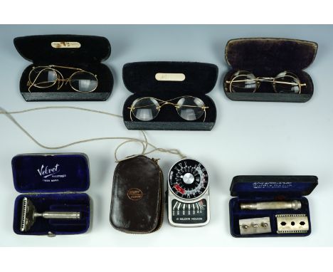 Vintage spectacles, pince nez, a 1920s safety razor and a camera light meter