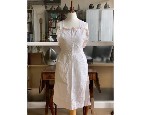 Costume including a vintage pink cotton smock, cotton house aprons, a white cotton sun or domestic bonnet, and a grey velvet 
