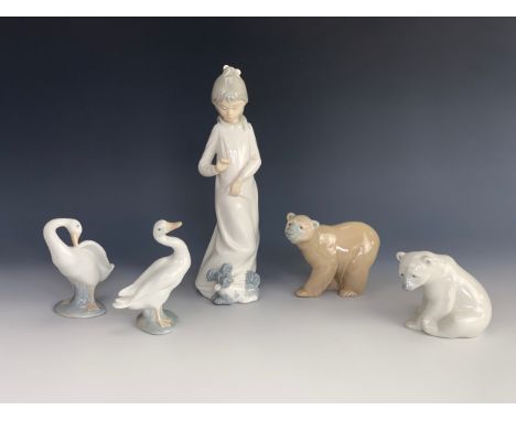 Two Lladro polar bears together with two Lladro geese and a Nao girl with puppy.