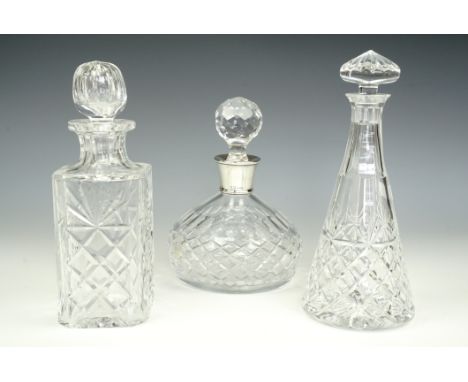 A silver-collared decanter and two others