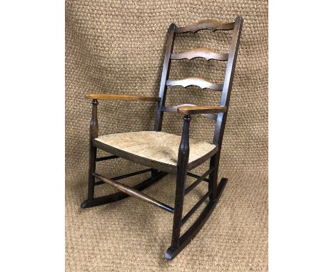A George V rush-seated ladder-back rocking chair, 87 cm