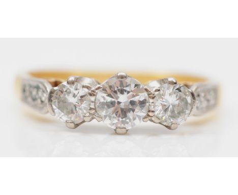 An 18ct gold three stone diamond ring, London 1976, claw set with brilliant cut stones, approximately 0.20, 0.50, 0.20cts, co