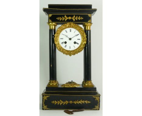 A French Empire style ebony four pillar mantel clock, with eight day drum movement, striking on a single bell. 41cm tall.  Pa