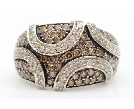 A 14KT white gold and diamond set dress ring, pave set with white and champagne brilliant cut stones, O, 8.9gm 