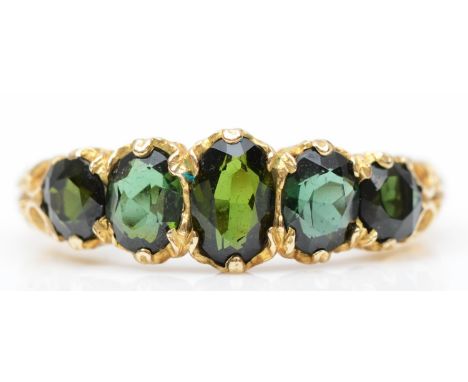 A vintage 9ct gold and green tourmaline ring, London 1975, fancy claw set with graduated mixed cut stones, P, 2.9gmIn very go