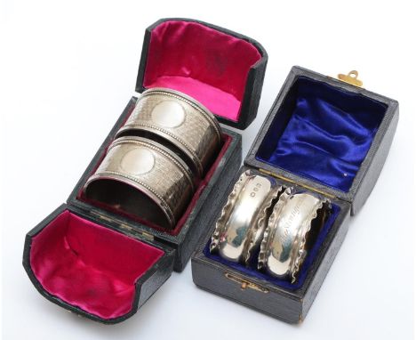 A silver pair of napkin rings, Birmingham 1916, with engine turned decoration, 43gm, case and another pair Birmingham 1894, o