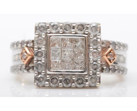 A 9ct white and diamond dress ring, the central cluster set with Princess cut stones, bordered by brilliants, the shoulders s