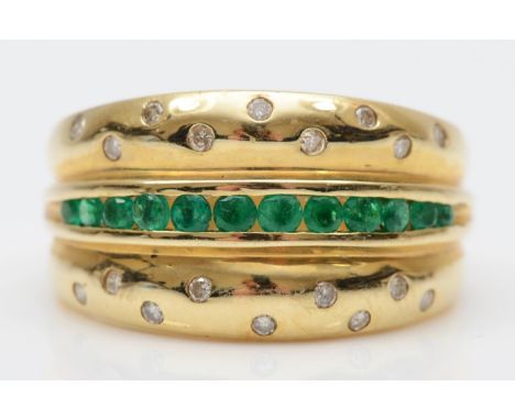 A 14K gold emerald and diamond three row ring, gypsy set with brilliant cut stones, O, 5.7gmgood condition but has surface sc