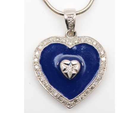 A 9ct white gold, enamel and diamond heart shape pendant, the brilliant cut stone within a blue field, single cut diamond bor