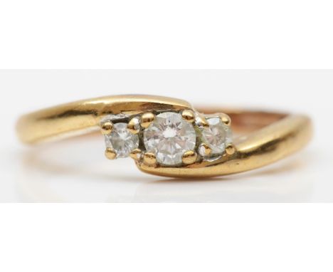 A 9ct gold three stone diamond ring, claw set with brilliant cut stones, approximately 0.25cts total, H/I, VS1/2, N, 2.6gm 