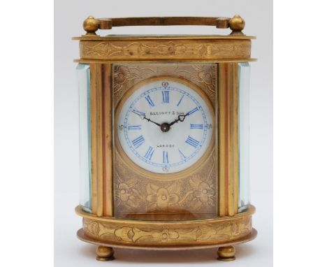 An Elliott &amp; Son eight day carriage clock, chased gilt case of oval form. 9cm tall. 