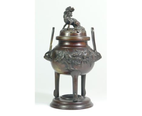 A Chinese bronze censor, the cast relief decorated with birds, having dragon mask handles, the lift off cover with a mytholog