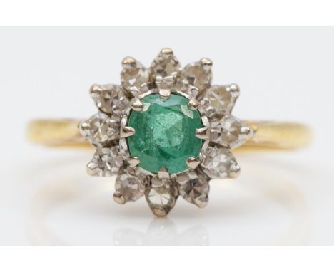 An 18ct gold emerald and diamond cluster ring, London 1976, L 1/2, 4.1gmEmerald has normal internal imperfections, otherwise 