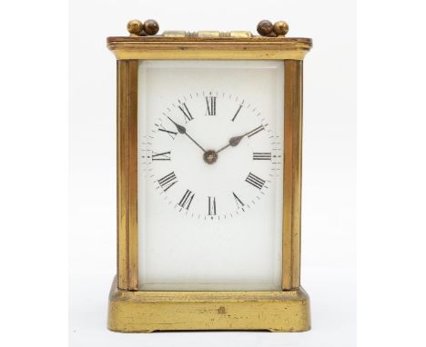 A brass eight day carriage clock, enamelled dial with Roman numerals, complete with travel case. 12cm tall. 
