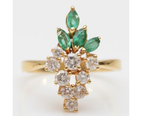 A gold, emerald and diamond dress ring, stamped 750, claw set with brilliant cut stones, colour estimate I/J, approximately 0