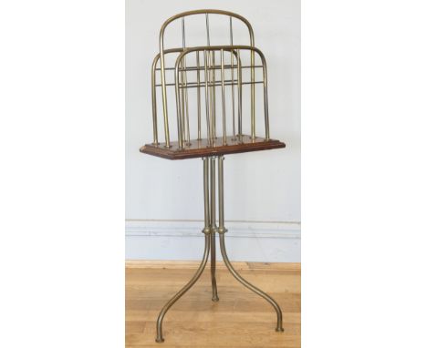 An Edwardian rotating magazine rack, the brass tripod base with mahogany and with three brass dividers above. H77cm, arched. 