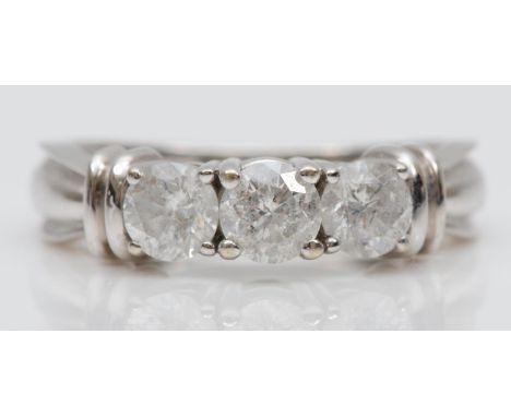 A 14ct white gold and diamond three stone ring, claw set with brilliant cut stones, estimated to weigh 0.33cts each, colour e