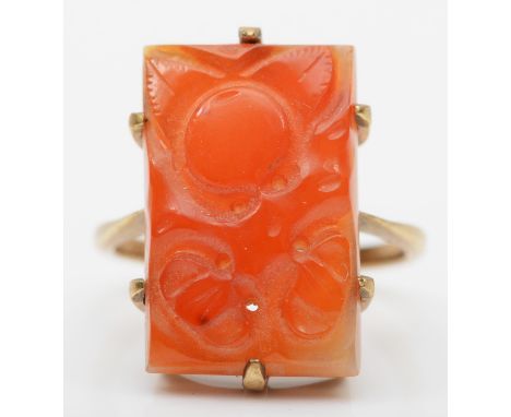 A gold mounted carved jadeite panel ring , stamped 10, depicting fruit, 20 x 13mm, P, 4.8gm 