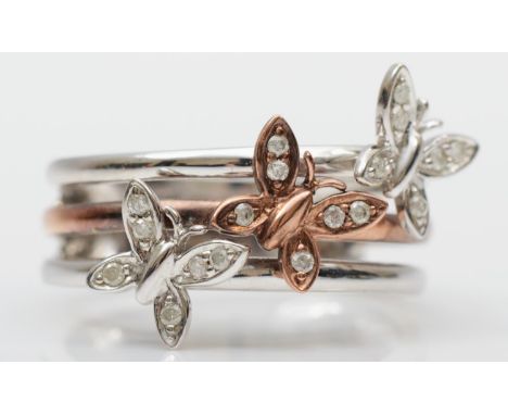 A 9ct white and rose gold diamond three butterfly ring, set with brilliant cut stones, K 1/2, 3.3gm 