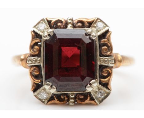 A 9ct gold garnet panel ring, the claws set with diamonds, 14 x 14 mm overall, L 1/2, 4gmvery minor abrasion on one corner, o