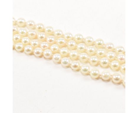 A silver and cultured pearl necklace. The necklace strung with&nbsp; 5 - 6mm round cultured pearls on a knotted string having