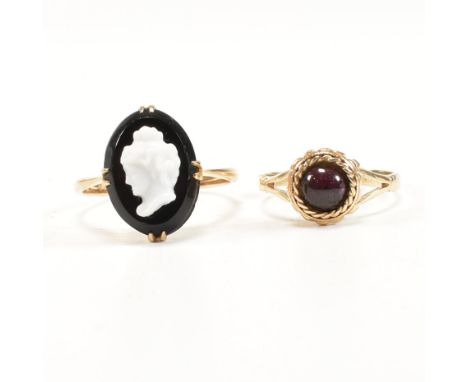 Two gold and gem set rings. The rings to include a&nbsp;15ct gold and garnet ring, the ring having a central garnet cabochon 