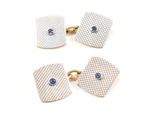 A pair of 18ct gold, sapphire and platinum cufflinks. The cufflinks having a central bezel set round cut sapphire mounted on 