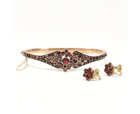 Victorian bohemian garnet bangle and cluster earrings. The bangle having a hinged fitting and safety chain. The earrings havi