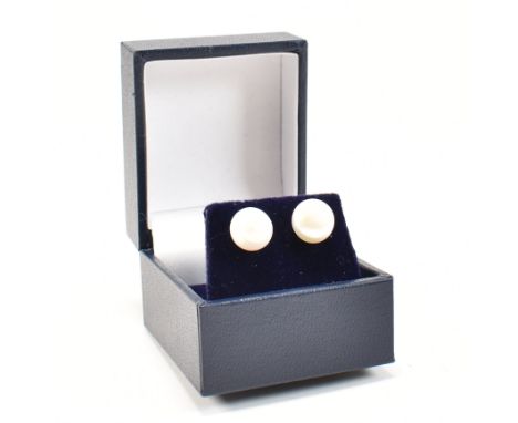 A pair of 925 silver and fresh water pearl stud earrings. The earrings having white fresh water pearls to straight post backs