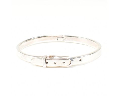A 925 silver belt bangle. The silver bangle bracelet having a belt buckle fastening with five belt holes. Marked 925. Measure