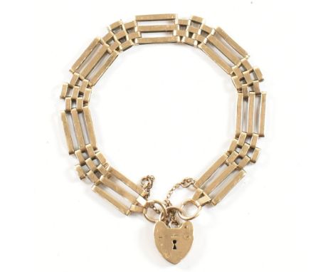 A hallmarked 9ct gold bracelet with heart padlock clasp. The 9ct gate link chain bracelet having a heart padlock clasp and sa