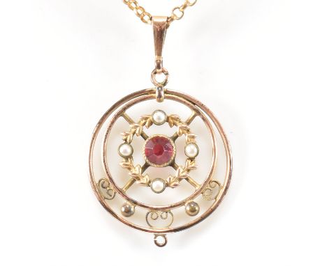 An Edwardian gilt metal, simulated pearl and paste pendant necklace. The circular pendant having a central round cut red past