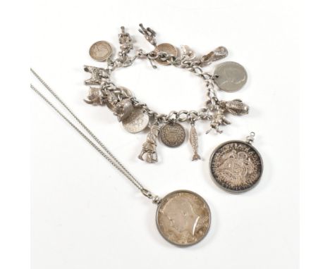 A vintage white metal charm bracelet and two coin pendant necklaces. The bracelet strung with multiple charms including pengu