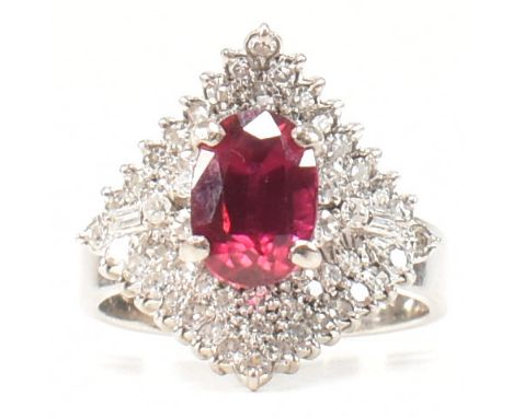 An 18ct white gold, synthetic ruby and sapphire doublet and diamond cocktail ring. The ring having a central oval cut synthet