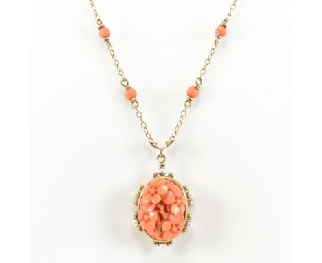 A hallmarked 9ct gold, carved precious coral and pearl pendant necklace. The necklace having precious coral carved into four 