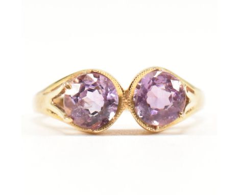 A hallmarked 9ct gold and amethyst two stone ring. The vintage ring being set with two round cut amethysts. Hallmarked for Bi