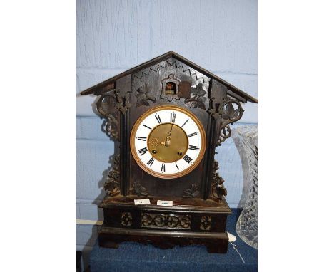 Dark wooden ornately carved cuckoo clock together with carved wooden shelf carved with an eagle, 46cm long