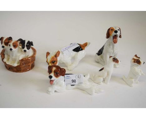 A group of Royal Doulton terrier models including seated dog HN1099, dog lying on its back HN1101, with ball HN1097, puppies 
