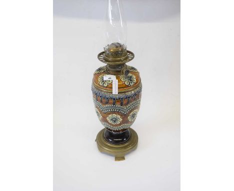 Lambeth Doulton oil lamp with glass chimney (crack to top), the lamp 32cm high