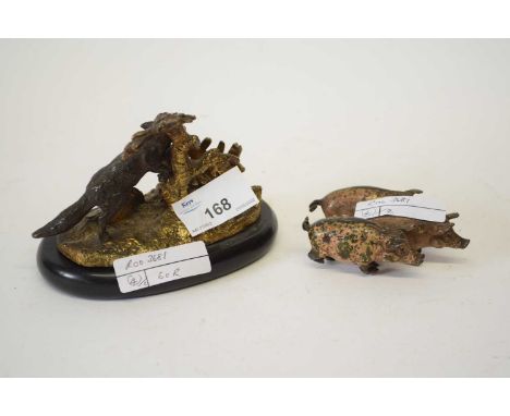 Metal model of three pigs, stamped Deschutzt, together with a metal model of a fox on black oval base