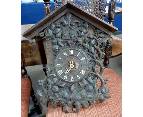 Late 19th century/early 20th century Continental cuckoo clock with arched case decorated with applied floral carved detail to