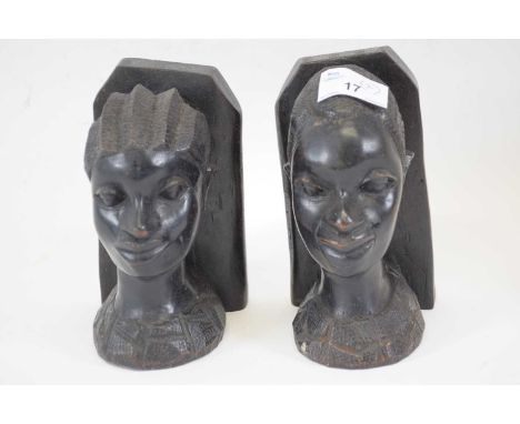 Two African tribal art carvings, heads modelled as bookends, probably West African, (2)