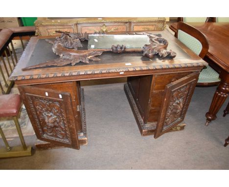 Victorian Gothic oak twin pedestal office desk, the rectangular top with inset writing surface over two pedestals with carved