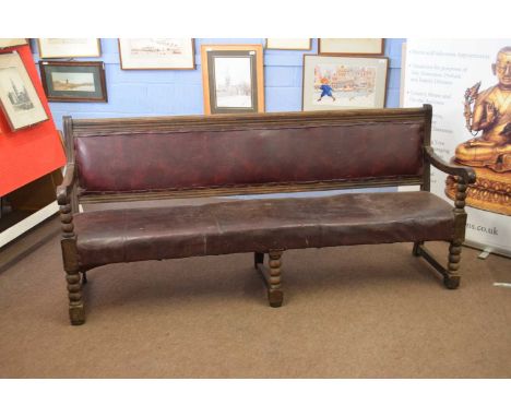 Victorian oak framed railway bench with upholstered seat and back, raised on bobbin turned legs, 204cm wide