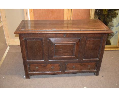 18th century oak mule chest with a hinged lid over a body with three panelled front over two drawers raised on stile feet, 13